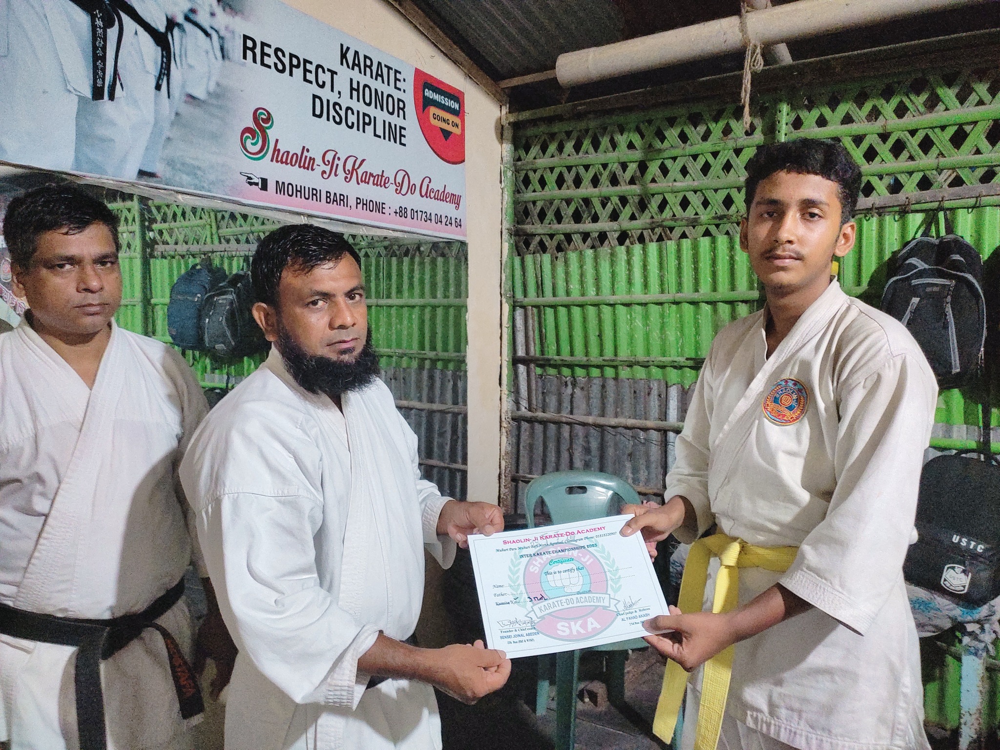 Student receiving a certificate at Shaolin-Ji Academy