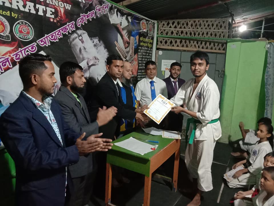 Student receiving a green belt certificate at Shaolin-Ji Academy